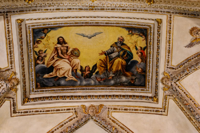 A painting of jesus and the holy spirit on the ceiling.