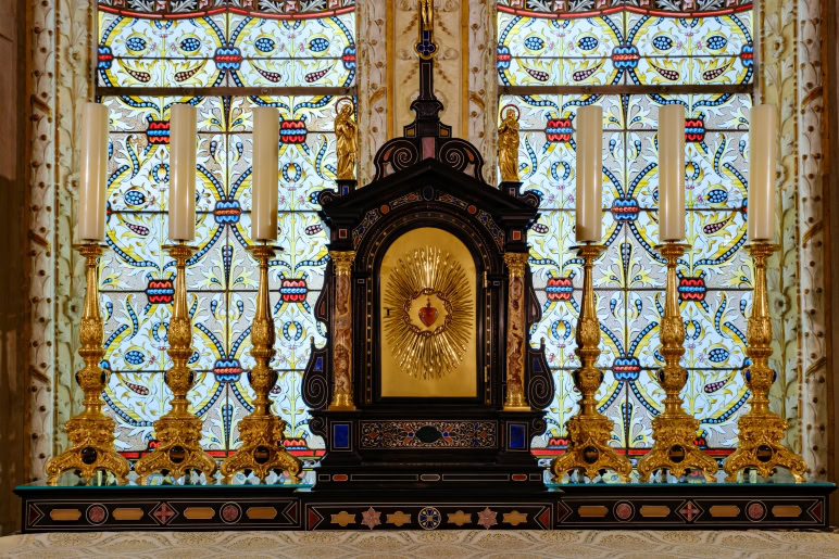 A large ornate altar with a large gold cross on it.